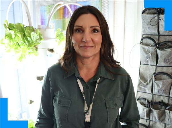  Amber Bowler stands in her classroom and smiles for the camera.